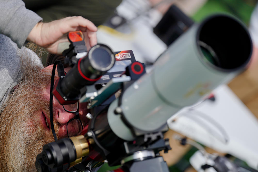 Chris Mandrell, project cooridinator for Southern Illinois University's dynamic eclipse broadcast, focuses a telescope ahead of the total solar eclipse on Sunday at Saluki Stadium in Carbondale, Ill.