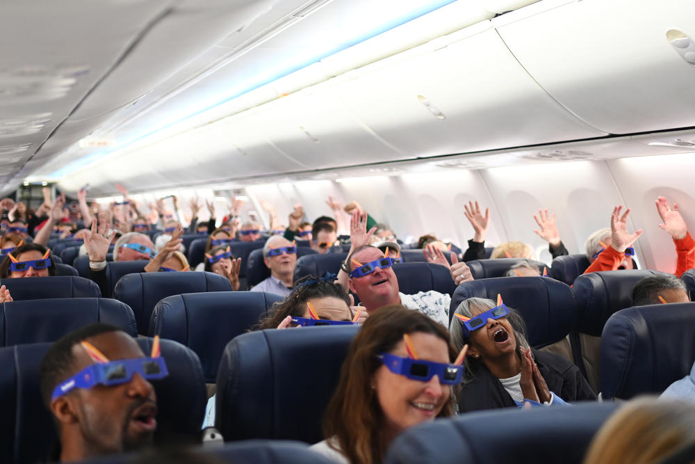 Passengers cheer as Southwest Flight 1910 departs highlighting the total solar eclipse from St. Louis to Houston, Texas at Lambert International Airport in St. Louis, Missouri.