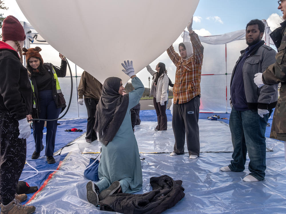 Students prepare a practice balloon for launch late last month. The ballooning project offers an opportunity for them to learn many skills they might someday use for space probes and satellites.