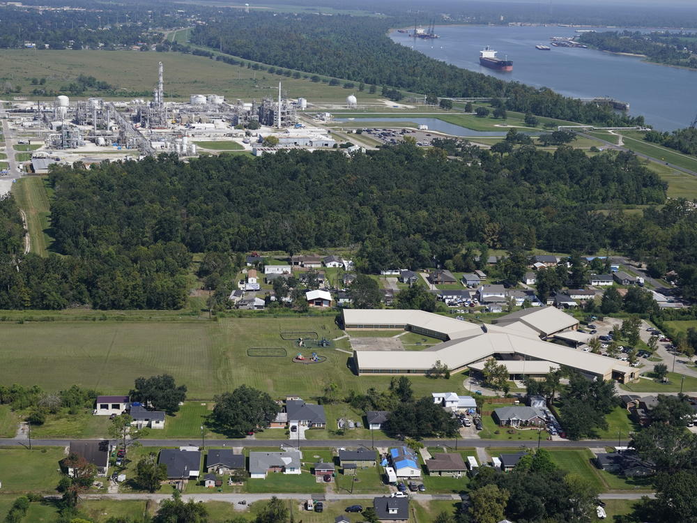 The Fifth Ward Elementary School and residential neighborhoods sit near the Denka Performance Elastomer Plant (back of photo) in Reserve, Louisiana. Less than a half mile away from the elementary school the plant makes synthetic rubber, emitting chloroprene which the EPA's new rule targets.