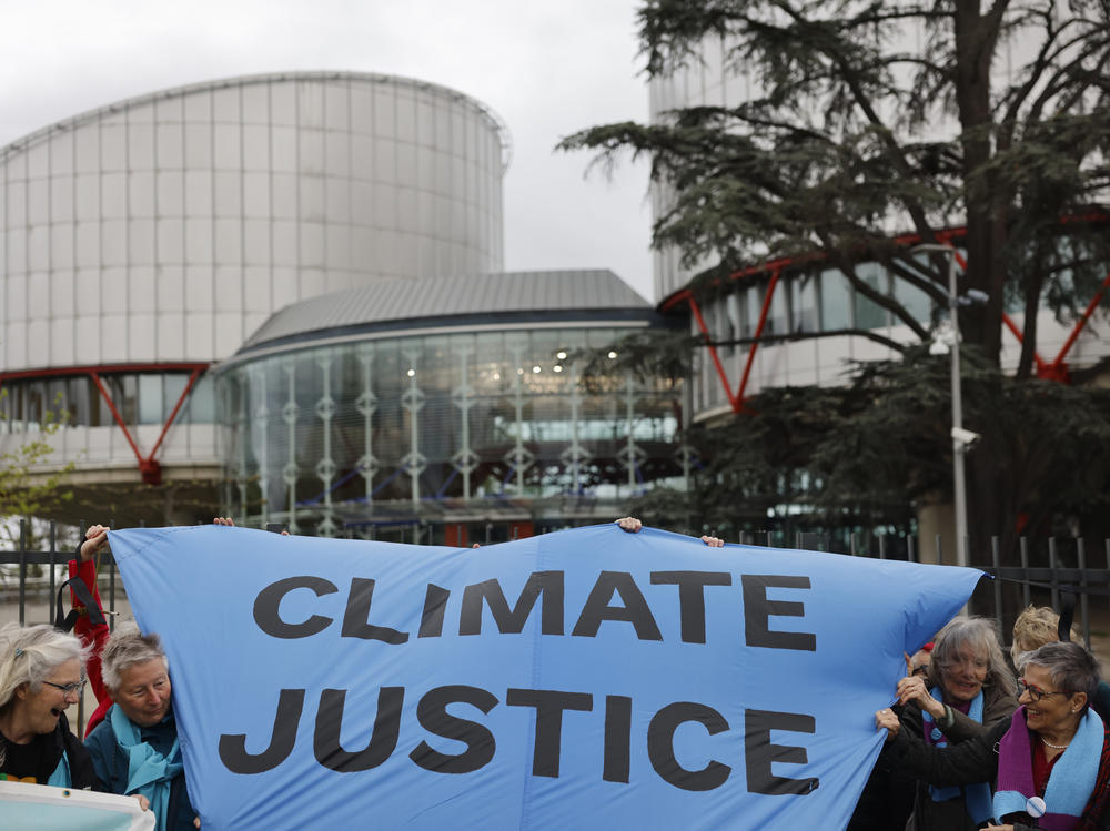 People demonstrate outside the European Court of Human Rights Tuesday, April 9, 2024 in Strasbourg, eastern France.