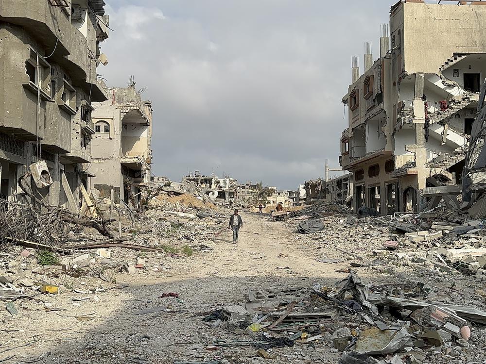 Palestinians returning to Khan Younis to survey the damage to their homes after Israeli forces withdrew from the city following a four-month battle with Hamas there.