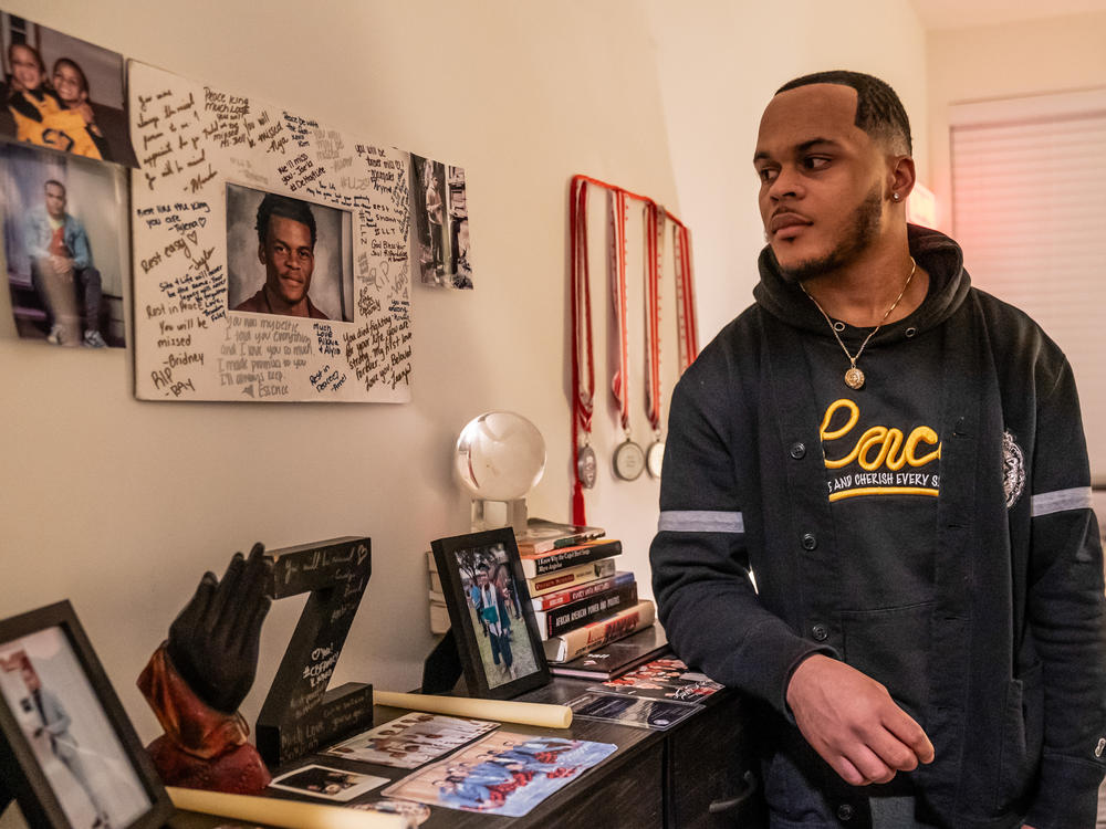 In his bedroom, Zion Kelly keeps his brother's memory alive by displaying photos of them in happier times.