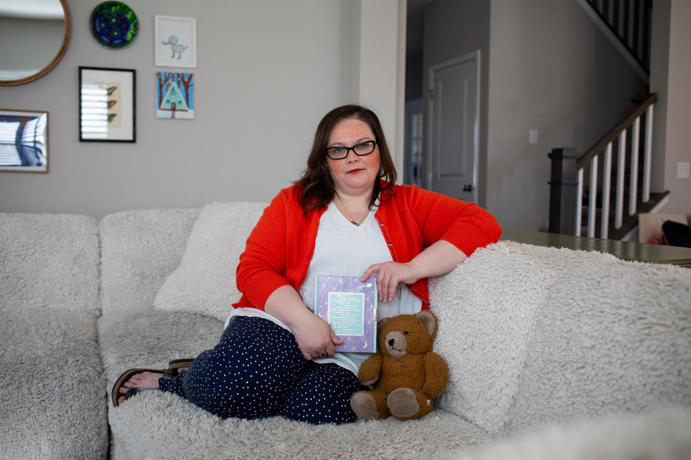 Meghan Britton holds her childhood journal and her brother's teddy bear at her home in Fort Wayne, Ind. The journal was given to her by her mother's friend after the death of her brother.