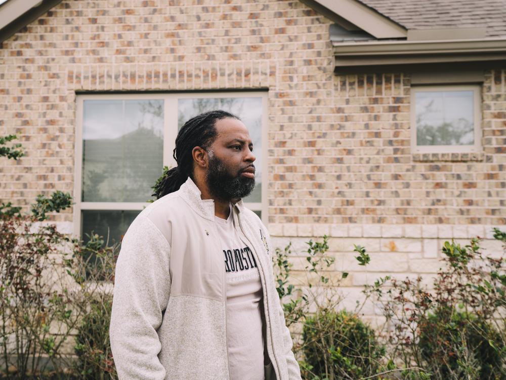 Edmund Garcia, an Iraq War veteran, stands outside his home in Rosharon, Texas. Like many vets, he was told if he took a mortgage forbearance, his monthly payments wouldn't go up afterward.