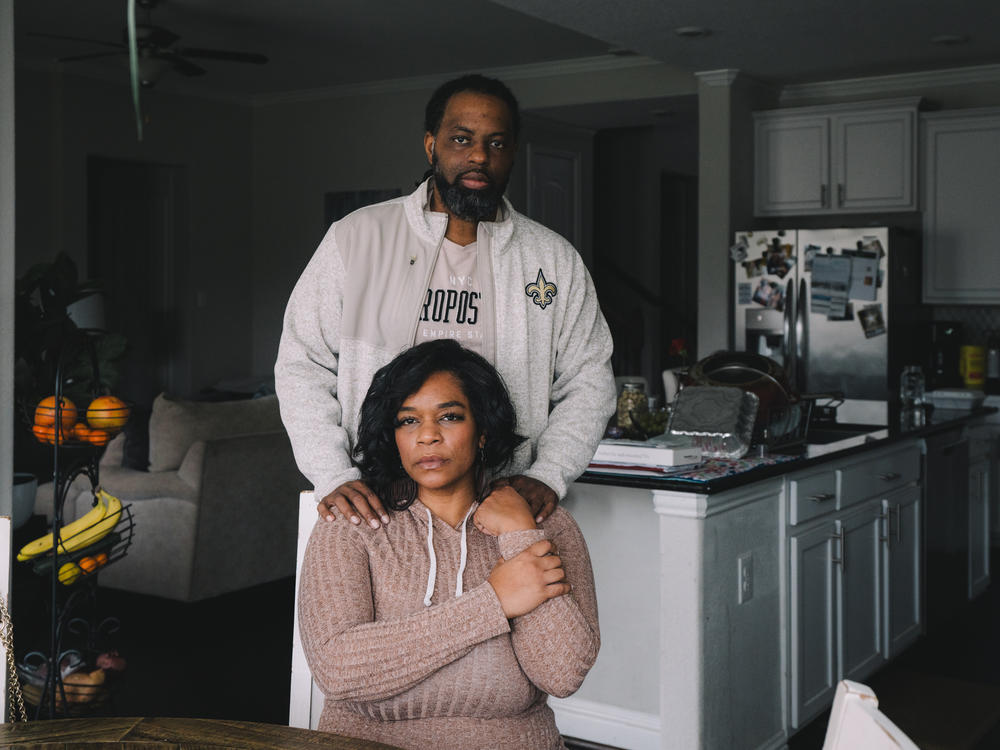 Edmund Garcia stands with his wife, Iris Garcia, inside their home, where they live with their four daughters. Iris lost her job during the pandemic and their mortgage company offered them a forbearance.<em> </em>