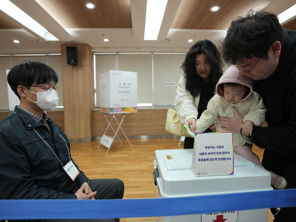 A family casts their votes for the parliamentary election at a polling station in Seoul, South Korea, Wednesday, April 10, 2024.