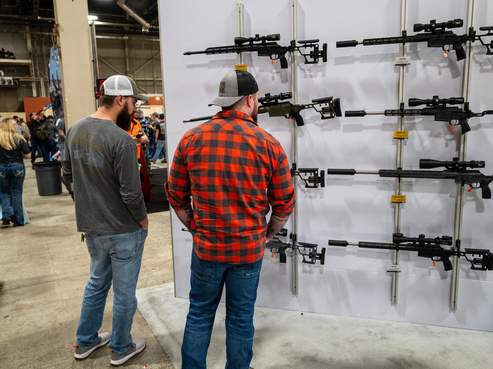 People look at guns and ammunition at the Great American Outdoor Show on Feb. 9 in Harrisburg, Penn. Former President Donald Trump spoke at the event.