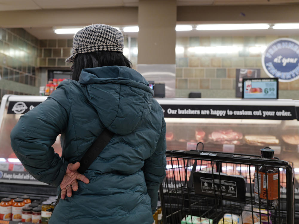 A customer shops at a grocery store in Chicago on Feb. 13, 2024. Annual inflation has eased significantly since two years ago but it has remained stubbornly above 3% this year.