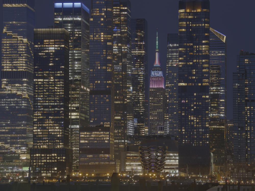 The Empire State Building is lit in pastel colors to mark Easter as it stands between the towers of Hudson Yards in New York City on March 31.