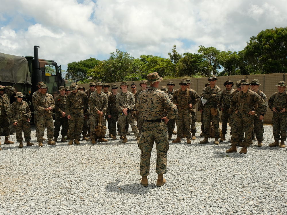 Marines of the 12th Marine Littoral Regiment assemble before a land navigation exercise on Okinawa.