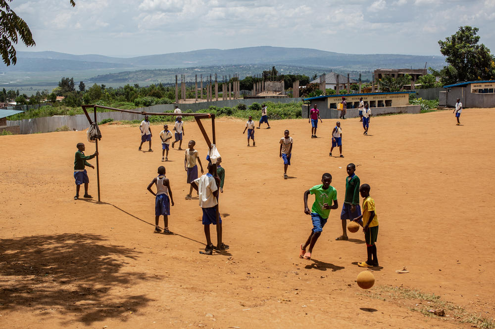 Students play near a genocide memorial site in Gahanga.