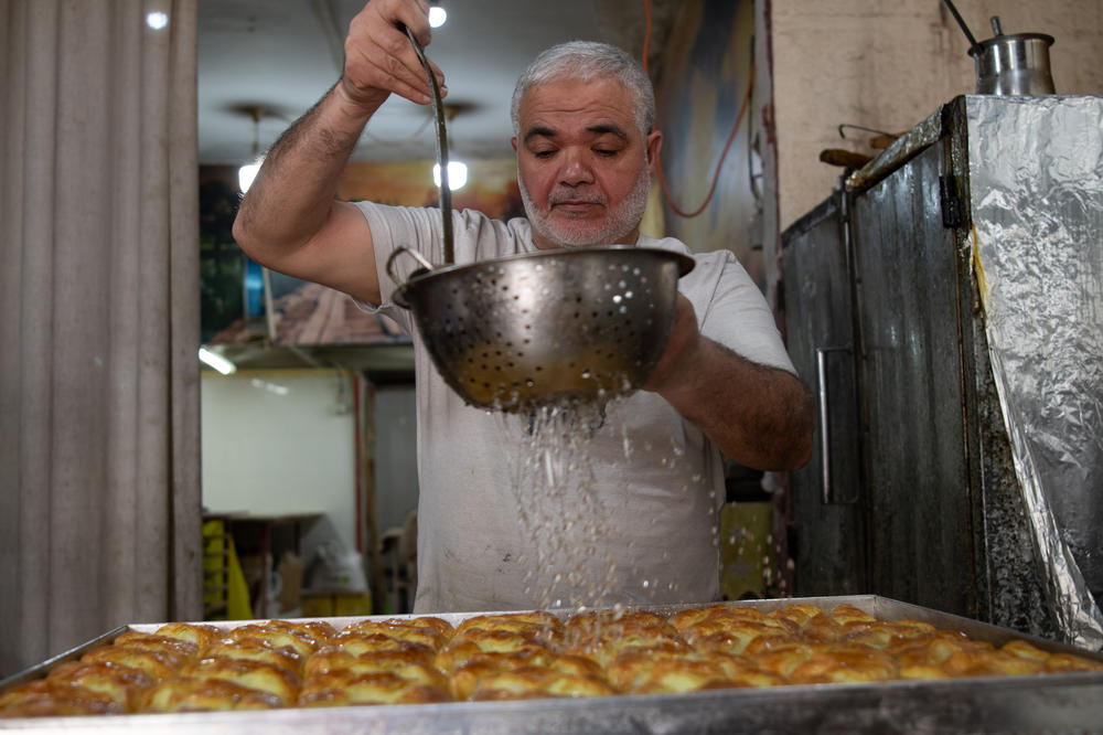 Rafe' Rummaneh prepares sweets at his bakery, April 9.