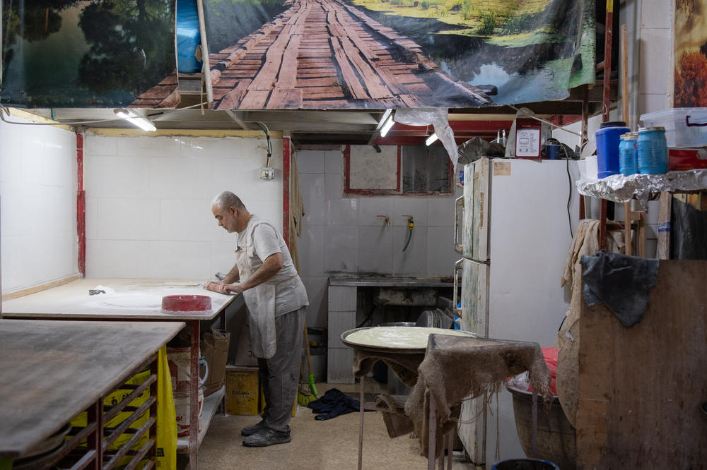 Rafe' Rummaneh prepares desserts at his bakery the Al-Am'ari refugee camp in Ramallah on April 9.