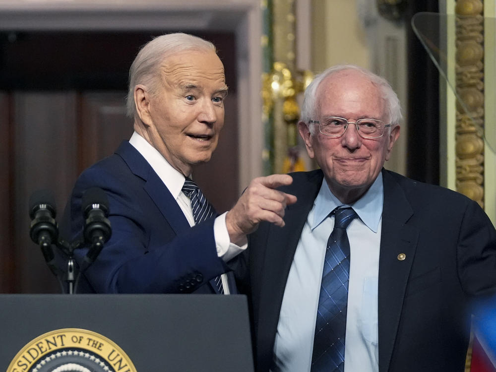 President Biden stands with Sen. Bernie Sanders, I-Vt., on April 3, 2024. Four years ago, Sanders endorsed Biden, and the former rivals worked together to craft policy proposals that bridged Democratic divides.
