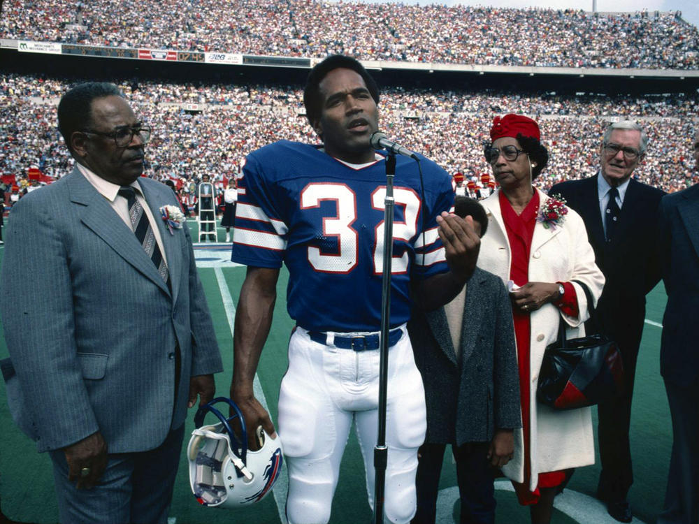 O.J. Simpson, accompanied by his parents, his son, Jason, and Ralph Wilson, owner of the Buffalo Bills, is inducted into the Wall of Fame in Rich Stadium on Sept. 14, 1980.