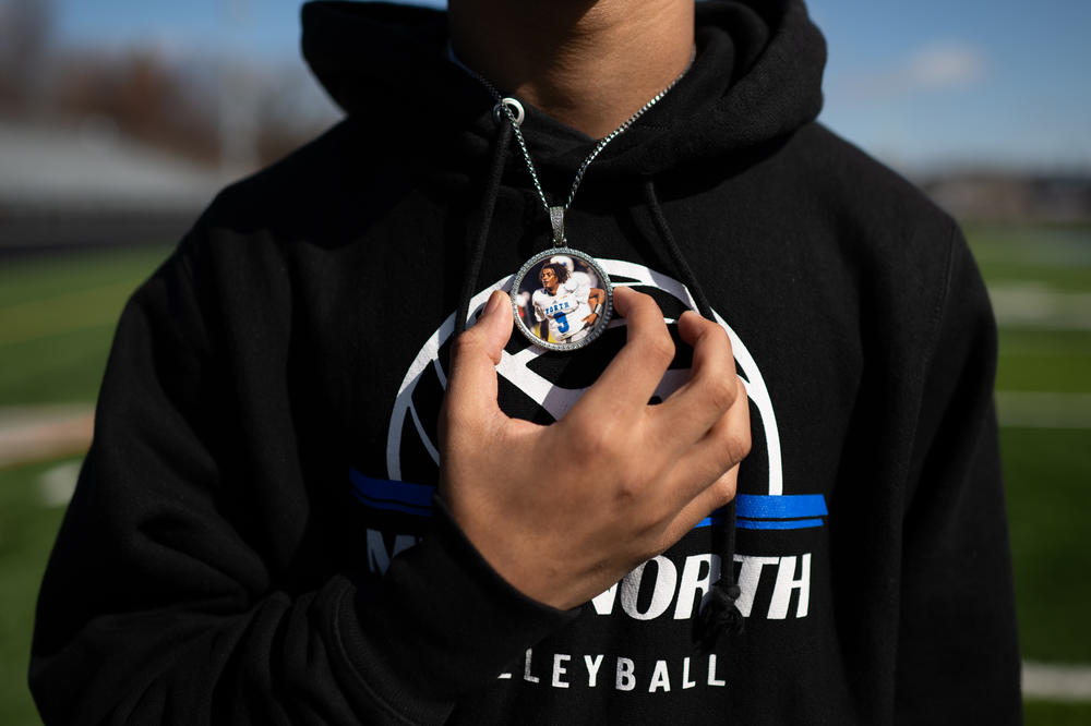 Jalen Beard holds a pendant he wears in remembrance of his friend.