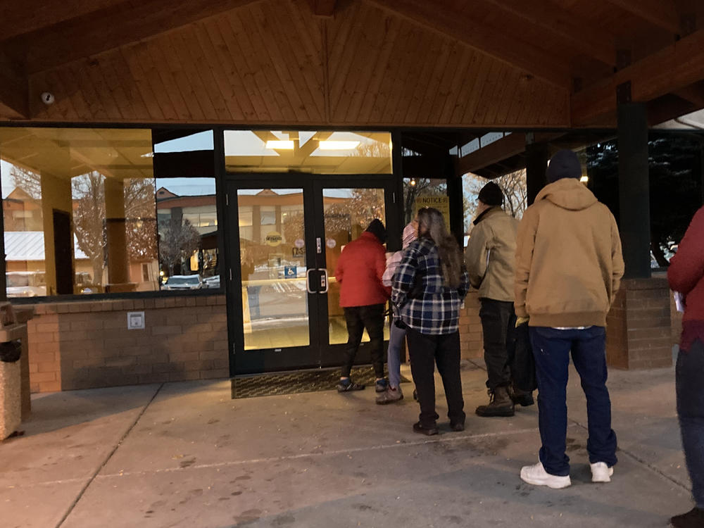 People line up outside a public assistance office in Missoula, Montana, before its doors open at 8 a.m., Oct. 27, 2023, to try to regain health coverage after being dropped from Medicaid, a government insurance program for people with low incomes and disabilities.