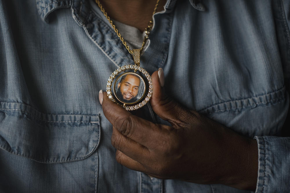 Tanya Warden, 55, holds a necklace with a photo of her son, Tyron Alexander, at her office in Philadelphia on Tuesday, March 26 2024.