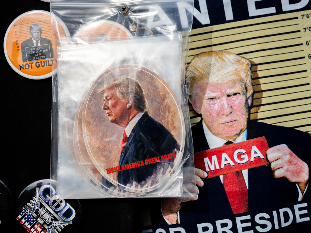 Merchandise is seen for sale during a Trump campaign rally in November 2023 in Houston.