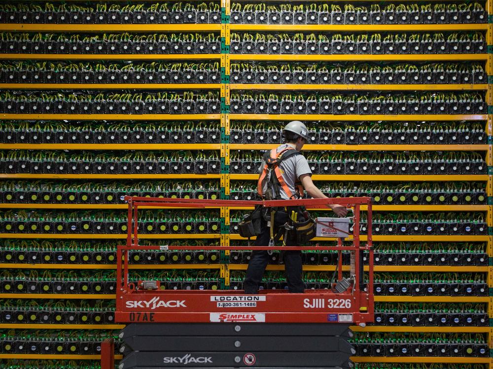 A technician inspects the backside of bitcoin mining at Bitfarms in Saint Hyacinthe, Quebec, Canada on March 19, 2018. There's also considerable debate about how the halving will impact the amount of energy involved in bitcoin mining.