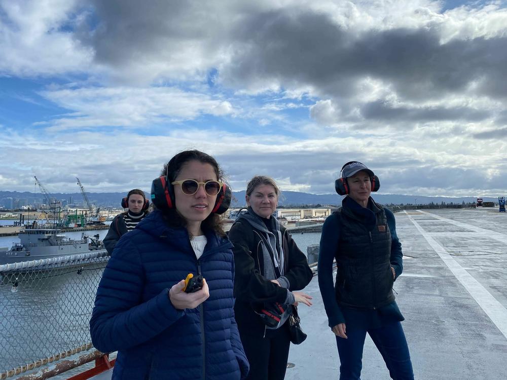 Jessica Medrado, a research scientist for SRI International, on a walkie-talkie, coordinates the test for solar geoengineering research. Behind her are (center) Kelly Wanser of SilverLining, the nonprofit that led fundraising for the program, and (right) Sarah Doherty, scientist at University of Washington and the program's director.