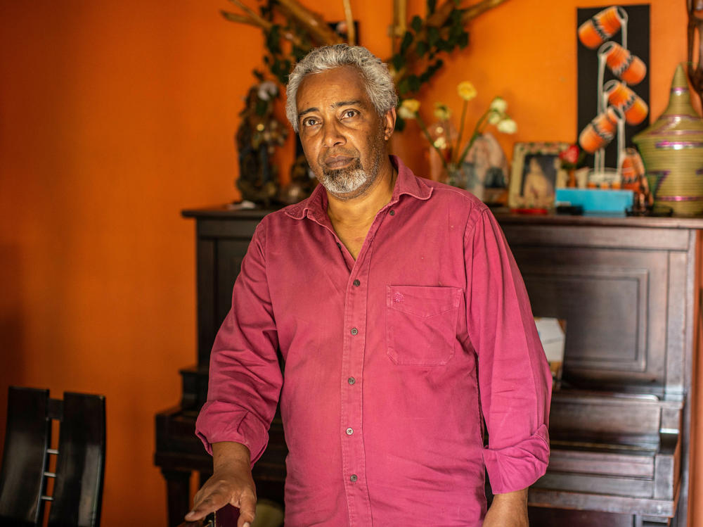 Albert Rudatsimburwa, a freelancer journalist reporting in the East African region poses for a portrait in his home.