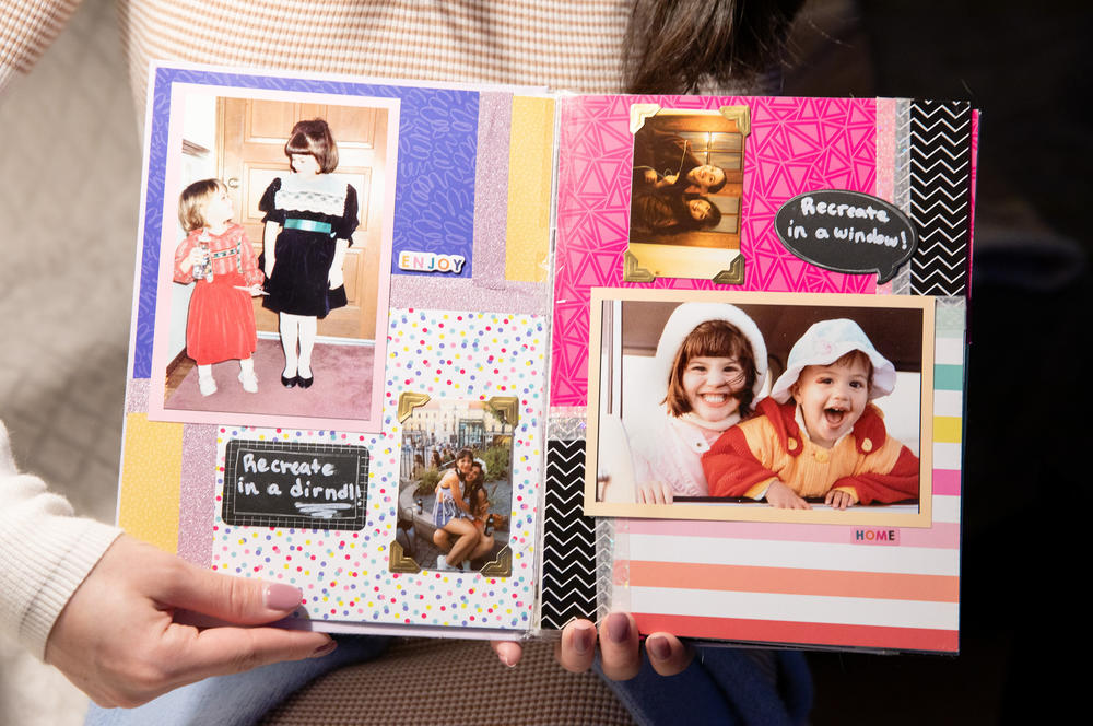 Sofie Elliott displays a scrapbook with photographs of herself and her sister, Simone Elliott.