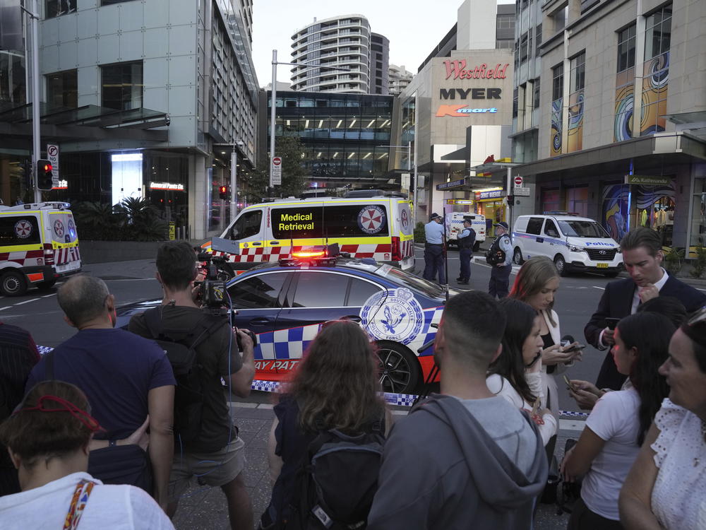 A crowd gathers outside the Westfield Shopping Centre in Sydney on Saturday after a stabbing spree killed six people and injured others.