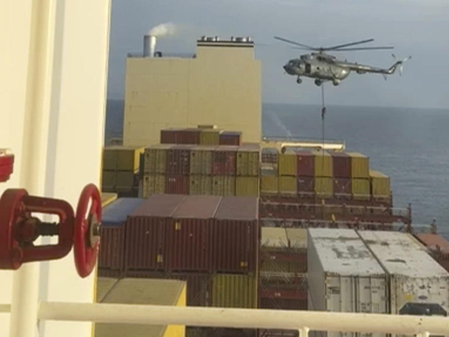 This image made from a video provided to The Associated Press by a Mideast defense official shows a helicopter raid targeting a vessel near the Strait of Hormuz on Saturday.
