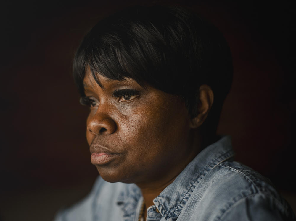 Tanya Warden, 55, sits for a portrait at her workplace in Philadelphia, Pennsylvania, on March 26, 2024. Warden's son, Tyron Alexander, was shot multiple times and died in October 2020.