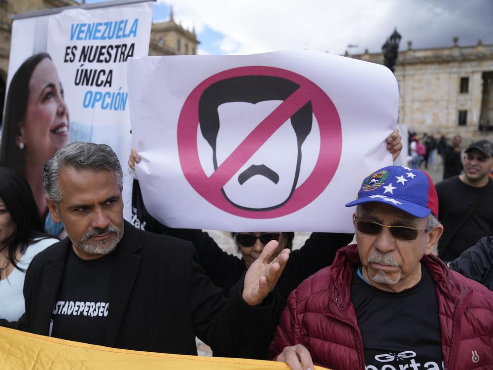 Supporters of Venezuelan political opposition leader María Corina Machado sing their national anthem during a protest demanding free and fair elections in Venezuela's upcoming election, in Bogotá, Colombia.