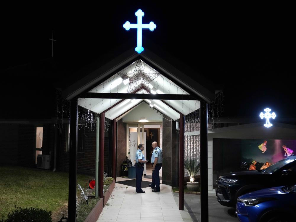 Security officers stand guard outside Orthodox Assyrian church in Sydney, Australia, Monday, April 15, 2024.