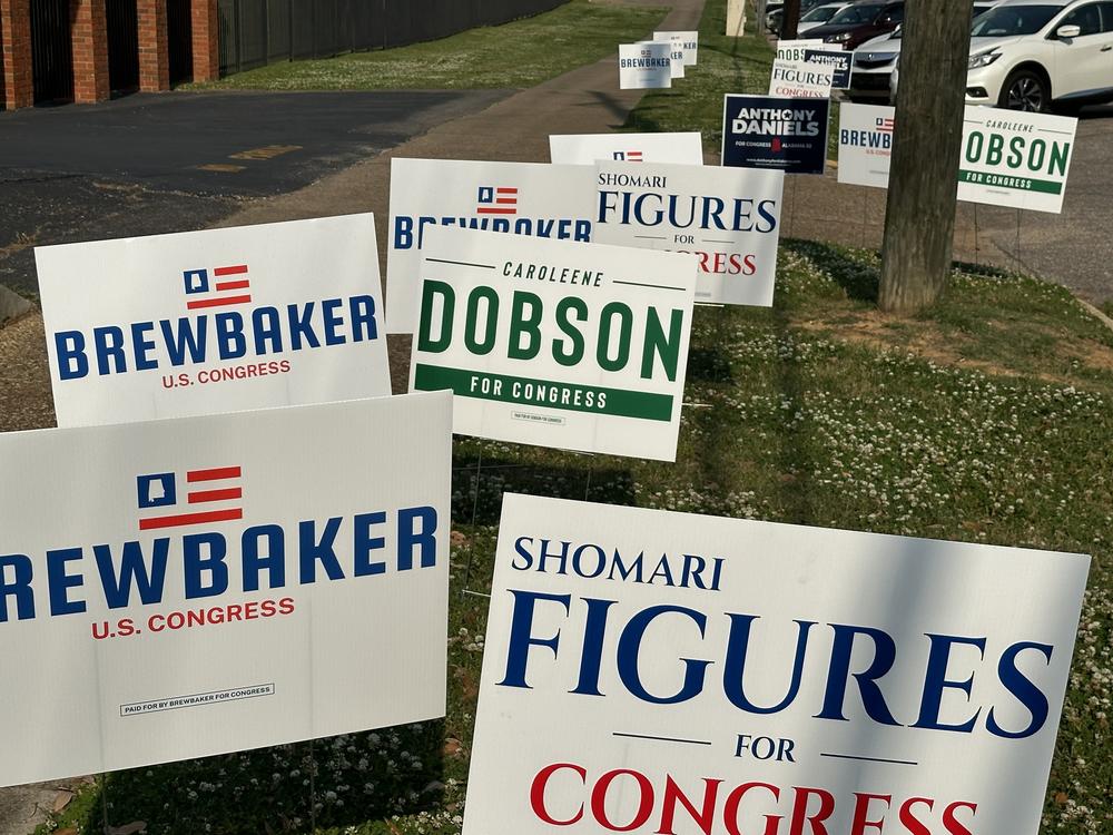 Candidate signs for Alabama's second congressional district race sit outside a polling center in Montgomery on Tuesday.