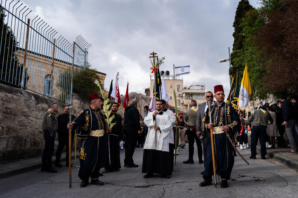 Christians hold a procession on the Mount of Olives outside Jerusalem on Palm Sunday on March 24, commemorating the day that Christians believe Jesus entered Jerusalem and was greeted by followers waving palms.