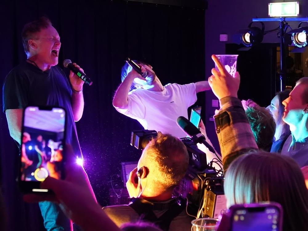 O'Brien performs onstage with a fan in Norway