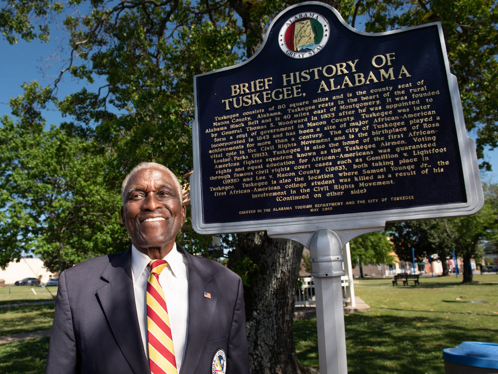Johnny Ford, former mayor of Tuskegee, Ala., and a current council member, stands near an accurate historical marker that was installed in the town square during his term as mayor. Ford is currently fighting to have a Confederate marker and statue removed from the square.