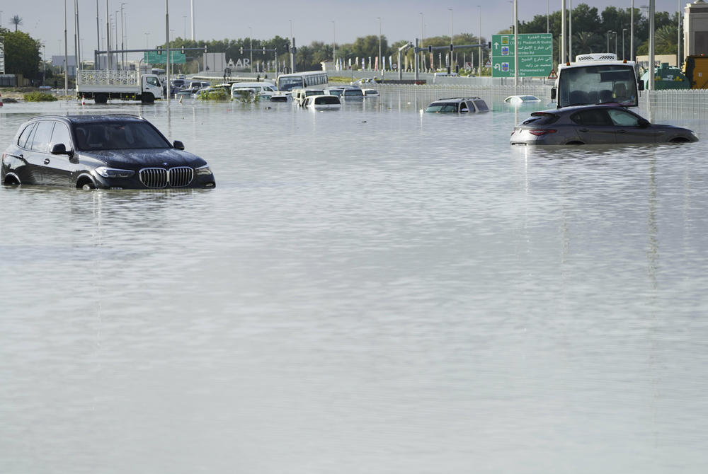 Vehicles sit abandoned in floodwater covering a major road in Dubai on Wednesday.