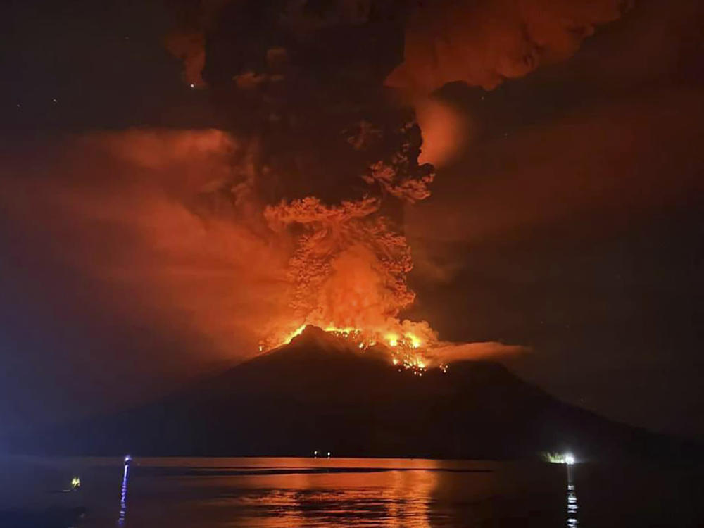In this photo released by Sitaro Regional Disaster Management Agency (BPBD Sitaro), hot molten lava glows at the crater of Mount Ruang as it erupts in Sanguine Islands, Indonesia, Wednesday, April 17, 2024.