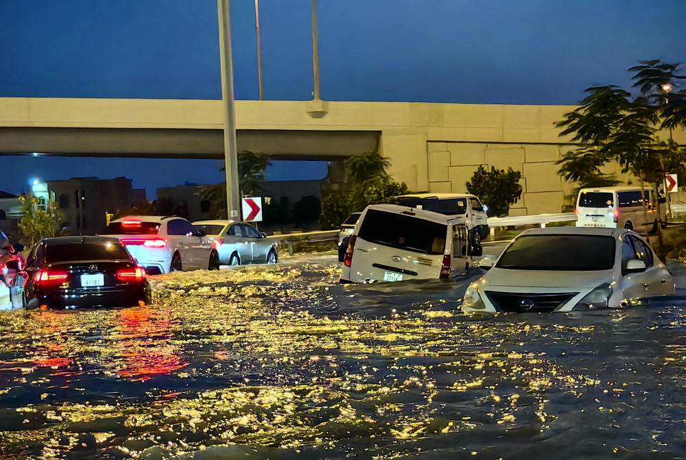 Cars drive in a flooded street following heavy rains in Dubai on Wednesday. Torrential rain caused floods across the United Arab Emirates, Bahrain and Oman.