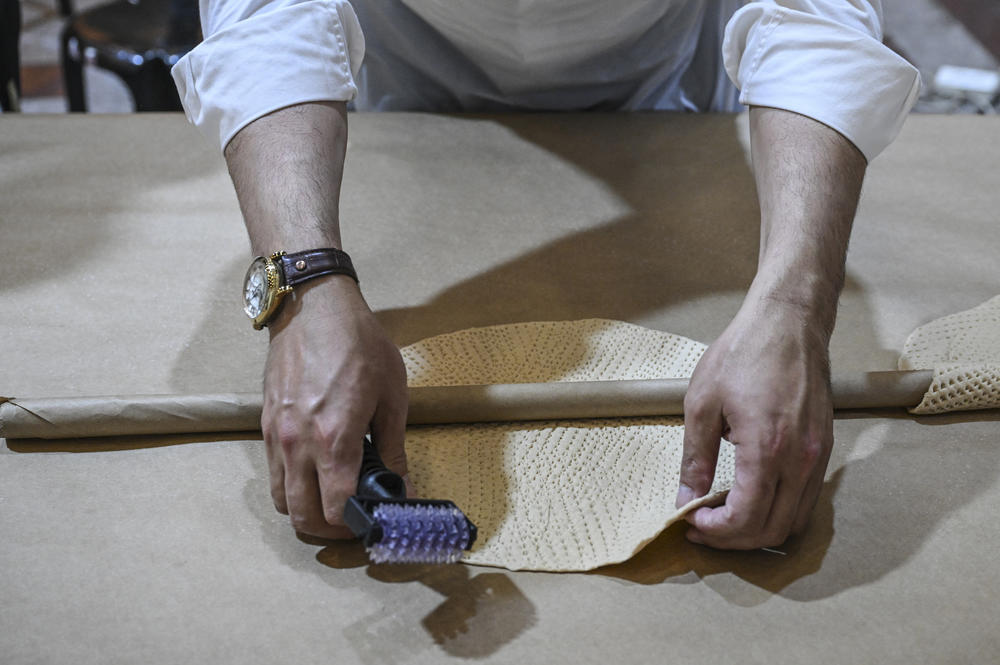 An Ultra-Orthodox Jewish man prepares Matzoth, unleavened bread, at a bakery in Jerusalem on April 18, 2024 on the eve of Judaism's Passover holiday. Religious Jews throughout the world eat Matzoth during the eight-day Pesach, or Passover holiday, to commemorate the Israelites' exodus from Egypt some 3,500 years ago.