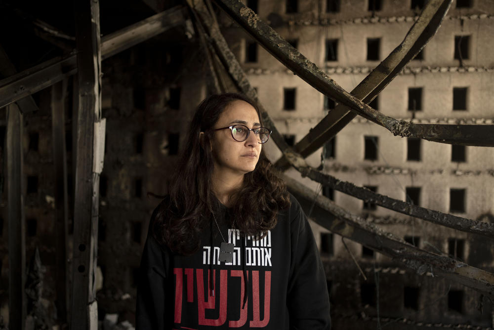 Sharon Alony Cunio cries as she poses for a portrait in the ruins of her home in Kibbutz Nir Oz on January 15. She and her family were kidnapped by Hamas militants on Oct. 7, 2023. Cunio and her 3-year-old twin daughters were released in November, but her husband, David, remains captive in Gaza. She recalls that meals during captivity would include canned food and a sometimes moldy piece of pita.