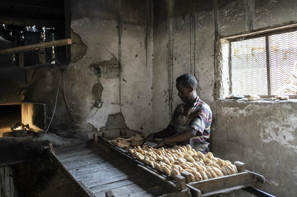 A baker at work in 2021 in Wadshrefy, Sudan. The bread in this part of the country is a fermented, somewhat spongy flatbread, similar to the injera bread of Ethiopia and Eritrea. In the Darfur region, bakers make a fluffier pita-like bread. Both breads serve as excellent scoops for meat, cheese, vegetables and bean dip.