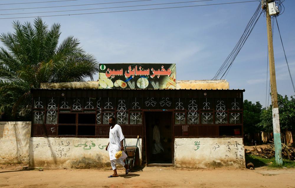 A Sudanese man walks out of a bakery in Darfur's state capital Niyala on October 11, 2019.