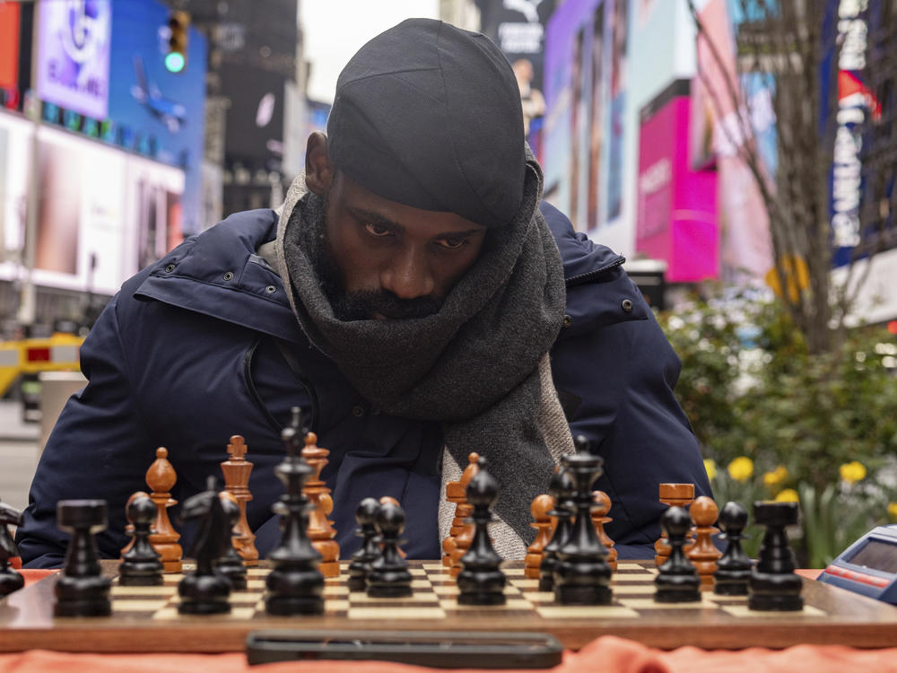 Tunde Onakoya, a Nigerian chess champion and child education advocate, plays a chess game in Times Square, Friday, April 19, 2024, in New York