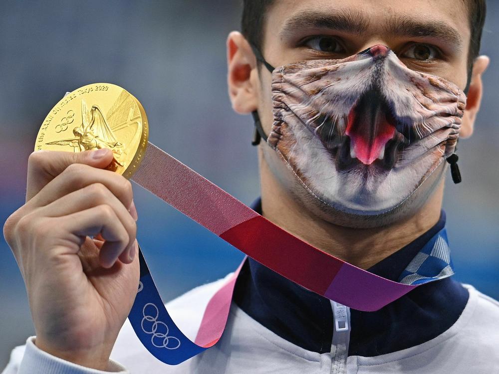 Russian gold medalist Evgeny Rylov, wearing a face covering, poses with his medal after the men's 200m backstroke during the Tokyo Olympic Games in 2021. His challengers questioned whether he competed with the aid of performance enhancing drugs.
