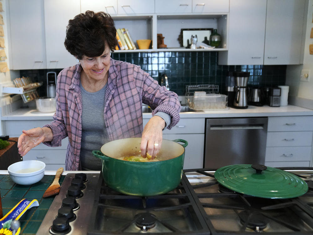 Nathan prepares matzo ball soup in her kitchen.