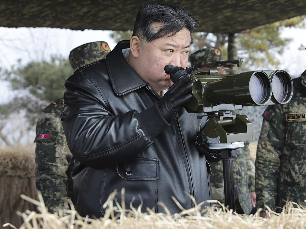In this photo provided by the North Korean government, North Korean leader Kim Jong Un, left, supervises artillery firing drills in North Korea Thursday, March 7, 2024.