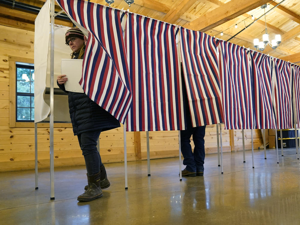 A voter leaves a voting booth in Concord, N.H., the during primary election on Jan. 23, 2024.