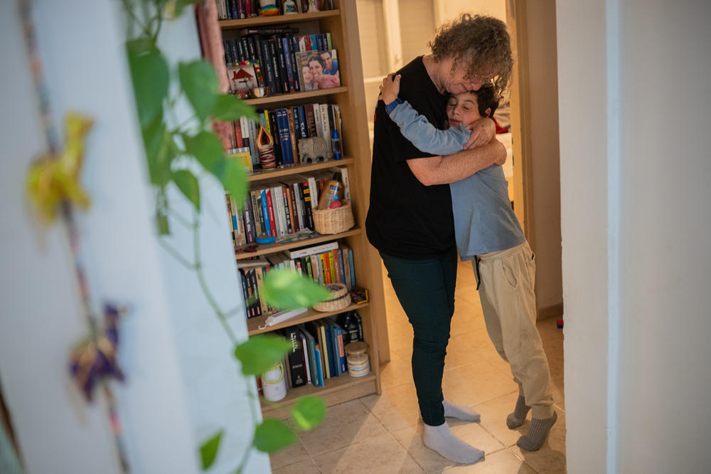 Aviva Siegel says good night to her grandson Roei, 9, at her daughter's home on Kibbutz Gazit on March 26.